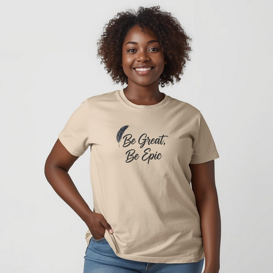 Woman wearing a beige t-shirt with 'Be Great, Be Epic' text and a feather graphic on a plain background